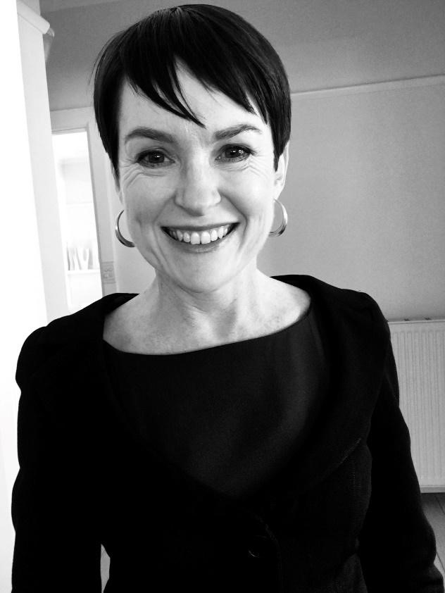 A black and white photo of a woman with short dark hair. 